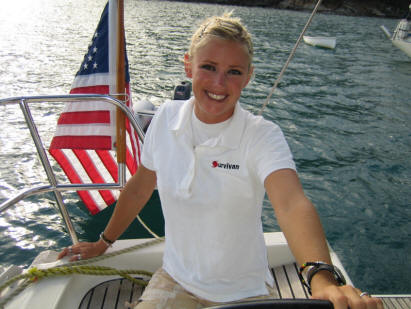 Larita Carter at the helm of the sailboat Survivan